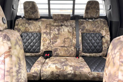 Luxury Line Kryptek camo seat covers on full rear bench, triple headrests, armrest, Highlander and black quilted inserts.