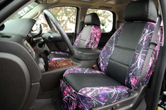 Front seats with Luxury Line Moon Shine Seat Covers (Muddy Girl), featuring pink camo and black textured bolsters.