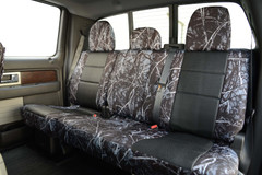 Rear bench seat view of Luxury Line Moon Shine Seat Covers with dark branch camo sides and black custom-fit inserts.