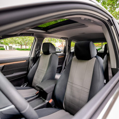 NeoSupreme Seat Covers installed on front seats in an SUV, two-tone black and gray fabric with a custom-fit finish.