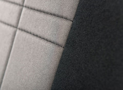 Close-up of NeoSupreme Seat Covers showing the durable fabric texture, precision stitching, and two-tone panel detail.