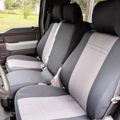 Front row bench seats in a truck protected with two-tone charcoal and light grey NeoSupreme seat covers, showing a precise, custom fit.