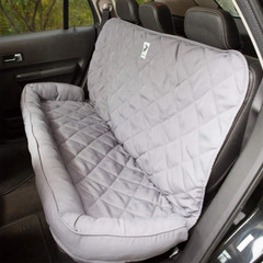 Gray quilted Universal Pet Seat Cover installed on a rear bench seat, featuring protective bolsters and a secure fit.