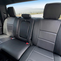 Luxury Line Carbon Fiber Seat Covers on a rear bench seat, featuring black carbon fiber textured inserts and a custom-fit center armrest.
