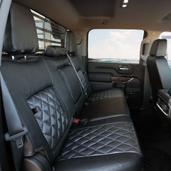 Rear bench seat view of Luxury Line Carbon Fiber Seat Covers, featuring black carbon fiber textured panels with a quilted diamond stitch.