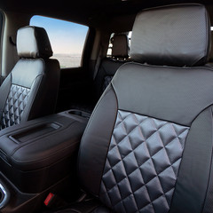 Luxury Line Carbon Fiber Seat Covers on front truck seats, featuring charcoal carbon fiber inserts with a quilted diamond stitch pattern.