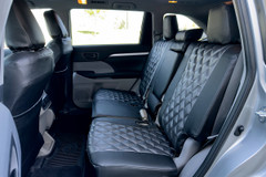 Luxury Line Carbon Fiber seat covers on rear bench and front seat backs, quilted centers, carbon weave, seat-back pockets.