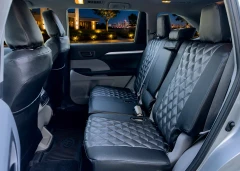 Luxury Line Carbon Fiber seat covers on rear bench and front seat backs, quilted centers, carbon weave, seat-back pockets.