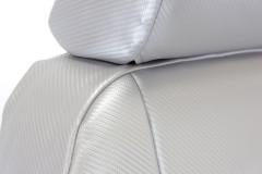 Detailed view of Luxury Line Carbon Fiber Seat Covers showing the snug custom fit of the headrest in light gray.