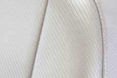 Close-up of Luxury Line Carbon Fiber Seat Covers showing the premium light gray carbon fiber weave and durable stitching.