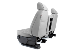 Rear view of Luxury Line Diamond Stitch Seat Covers in light gray, showing built-in storage pockets and custom console/cupholder openings.
