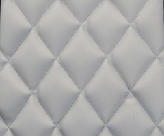 Close-up of Luxury Line Diamond Stitch Seat Covers in light gray, showing the detailed quilted diamond stitching and leatherette texture.