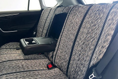 Luxury Line Saddle Blanket seat covers on rear bench, heathered gray weave with black stripes and armrest cupholders down.