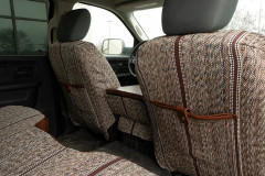 Luxury Line Saddle Blanket seat covers on front backs, heathered weave with brown stripes and leatherette storage pockets.