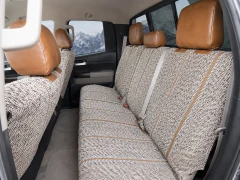 Rear bench seat of Luxury Line Saddle Blanket Seat Covers, durable woven fabric with brown leatherette headrests.