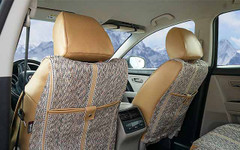 Rear view of Luxury Line Saddle Blanket Seat Covers in a car, showing woven fabric and tan custom-fit headrests.