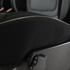 Close-up of the seat base on a Semi-Custom Pro Mesh Seat Cover, showing the tailored fit around seat adjustment controls and silver trim.