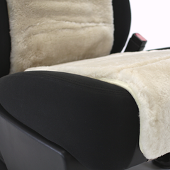 Detailed view of the ivory sheepskin vest on a black seat cushion, offering premium comfort and a secure tailored fit.