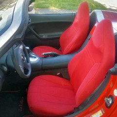 High-back bucket seats in a red convertible outfitted with vibrant red custom-fit neoprene seat covers, creating a bold, sporty, and unified look for the vehicle's interior.