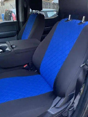 Custom-fit neoprene seat covers in blue and black, featuring a premium diamond-quilted center pattern and a matching center console cover.