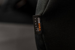 Extreme close-up of the official Toyota Waterproof Cordura Fabric brand label on a black heavy-duty custom seat cover.