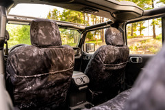 Back of front seats featuring Kryptek Typhon camo seat covers with functional map pockets and custom fit.