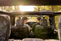 Lifestyle view from inside a Jeep with Kryptek Typhon camo seat covers, perfect for open-top off-road adventures.