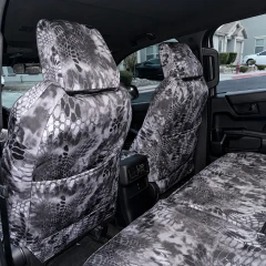 Rear view of front seats equipped with Kryptek® Waterproof Camo seat covers in the "Raid" pattern, featuring integrated storage pockets.