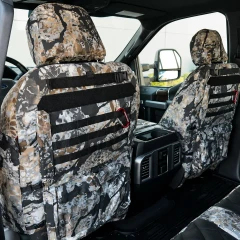 Luxury Line Kryptek camo seat covers on seat backs with black MOLLE, Velcro patch strip, base pockets, earth-tone scale camo.