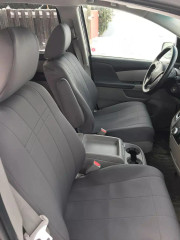 Front seats of a vehicle protected by solid light-grey neoprene seat covers, offering a clean, uniform look and durable protection for daily use.