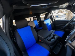 A full set of blue and black neoprene seat covers installed in a truck, providing comprehensive protection for both front and rear rows with a vibrant, athletic aesthetic.