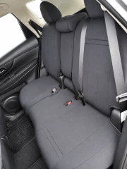Rear bench seat of an SUV completely covered with dark grey neoprene, demonstrating a precise, tailored fit that maintains full functionality of seat belts and folding mechanisms.