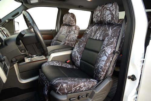 Luxury Line Moon Shine Seat Covers on front truck seats, featuring branch camo sides and black Sof-Touch center inserts.
