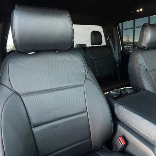 Close-up of Luxury Line Carbon Fiber Seat Covers in black, showing the detailed carbon fiber weave and custom fit.