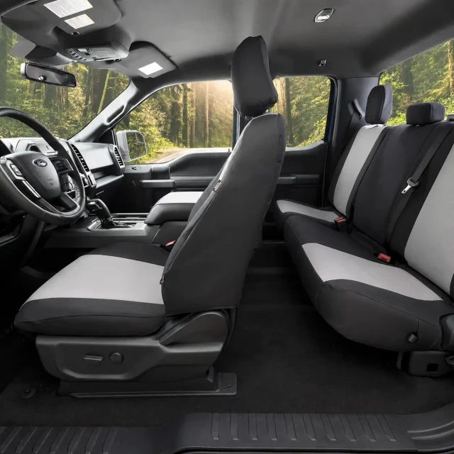 Atomic Pro-Tect Seat Covers installed in a truck, two-tone black and gray heavy-duty fabric for front and rear seats.