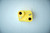 A yellow air blow gun wall mount with encased magnets for secure hold