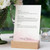 Wedding Menus, elegant wedding menu card displayed on a wooden stand with floral decor and candle in the background.