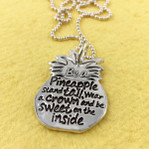 Be a Pineapple Inspirational Necklace on a bright yellow background