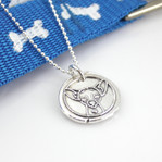 Chihuahua Wax Seal Inspired Necklace shown next to a blue leash with white dog bones