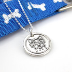 Yorkshire Terrier | Yorkie Wax Seal Inspired Necklace laying with a blue leash