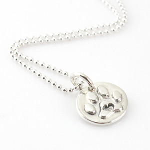 1/2" round silver paw print with a heart in the center on a silver bead style chain, laying on a white background, looking from slight left front side - ready to ship