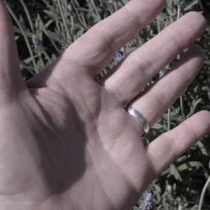 Ring shown on hand to show band