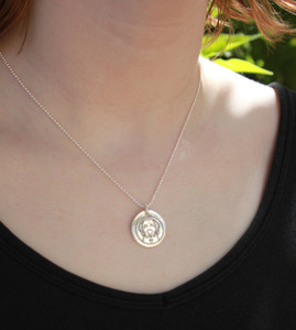 Dog Wax Seal Inspired Necklace on a model in a black shirt