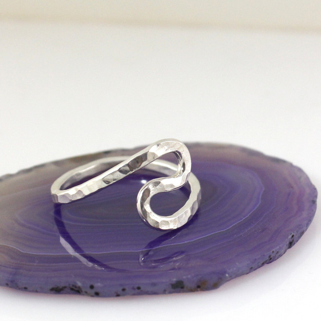 Size 10-1/2 Sterling silver Rustic Wave Ring shown setting on a purple flat surface