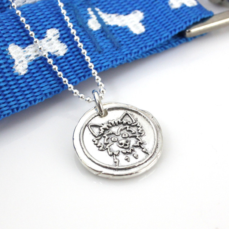Yorkshire Terrier | Yorkie Wax Seal Inspired Necklace laying with a blue leash