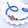 Elegant Meenakari Rakhi with Royal Blue Thread