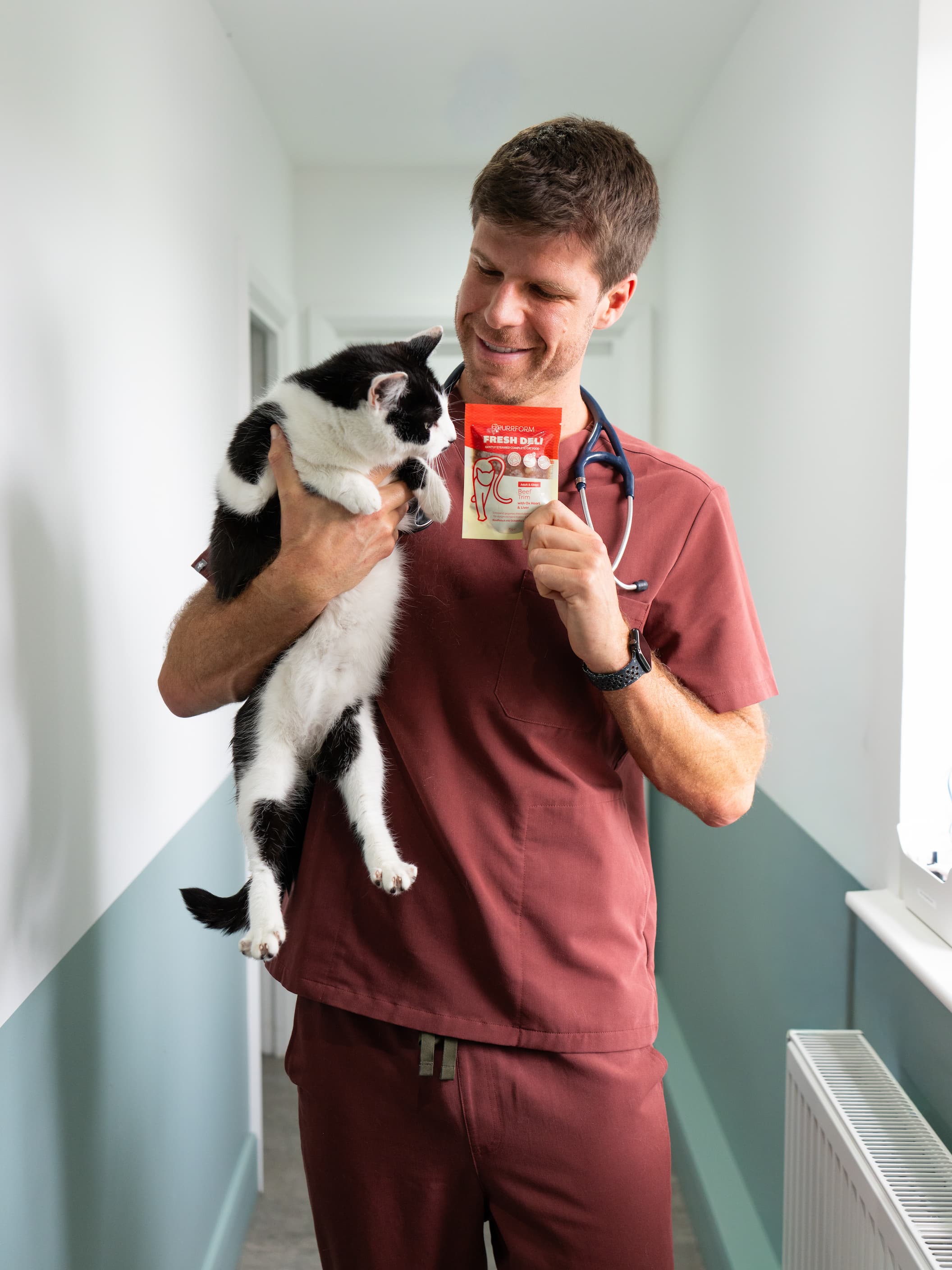 Dr. Michael Lazaris, veterinarian, holding his cat