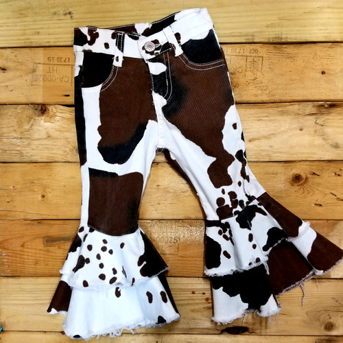 Product photo of the COW PRINT BELL BOTTOM JEANS baby outfit, showing the full set, print, and fabric, available at Forever And Always Online.