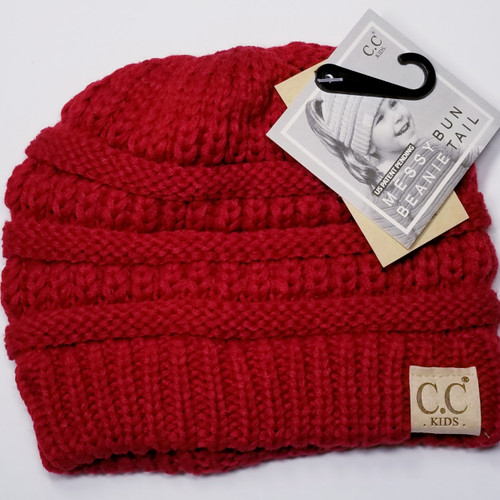 Product photo of the KIDS C.C MESSY BUN BEANIE RED baby beanie hat, showing the soft knit fabric, color, and pom pom detail, available at Forever And Always Online.