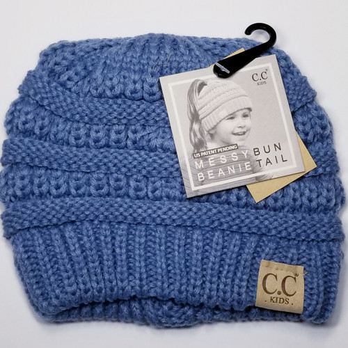 Product photo of the KIDS C.C MESSY BUN BEANIE DENIM baby beanie hat, showing the soft knit fabric, color, and pom pom detail, available at Forever And Always Online.